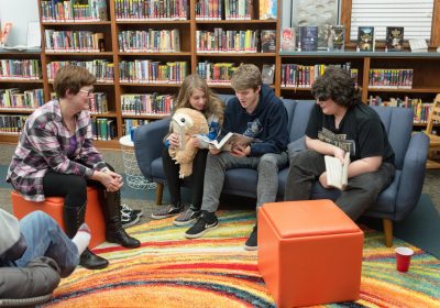 TINA CUNNINGHAM (LEFT) WITH TEEN READING LOUNGE YOUTH AT THE HOLLIDAYSBURG AREA PUBLIC LIBRARY.