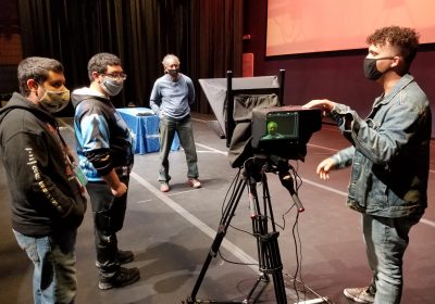 From left, Esperanza Arts Center mentor fellows and production assistants Emmanuel Figueroa and
Ozias Ayala join Bruce Savage, media production professor at Esperanza College, and 
Josue Lora, production manager for the LuminArias video series, in preparing for a filming.