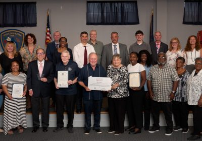 Members of the Upper Chichester Heart & Soul team, Upper Chichester Board of Commissioners, PA Heart & Soul staff and partners stand posing with their plaques and other recognition of becoming a PA Heart & Soul community. PHOTO BY RUSTBELT MAYBERRY PHOTOGRAPHY.