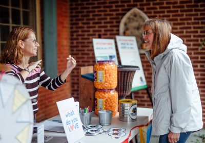 Lifelong Dillsburg resident Gina Staton talks with a neighbor about Community Heart & Soul at the annual Farmers Fair.